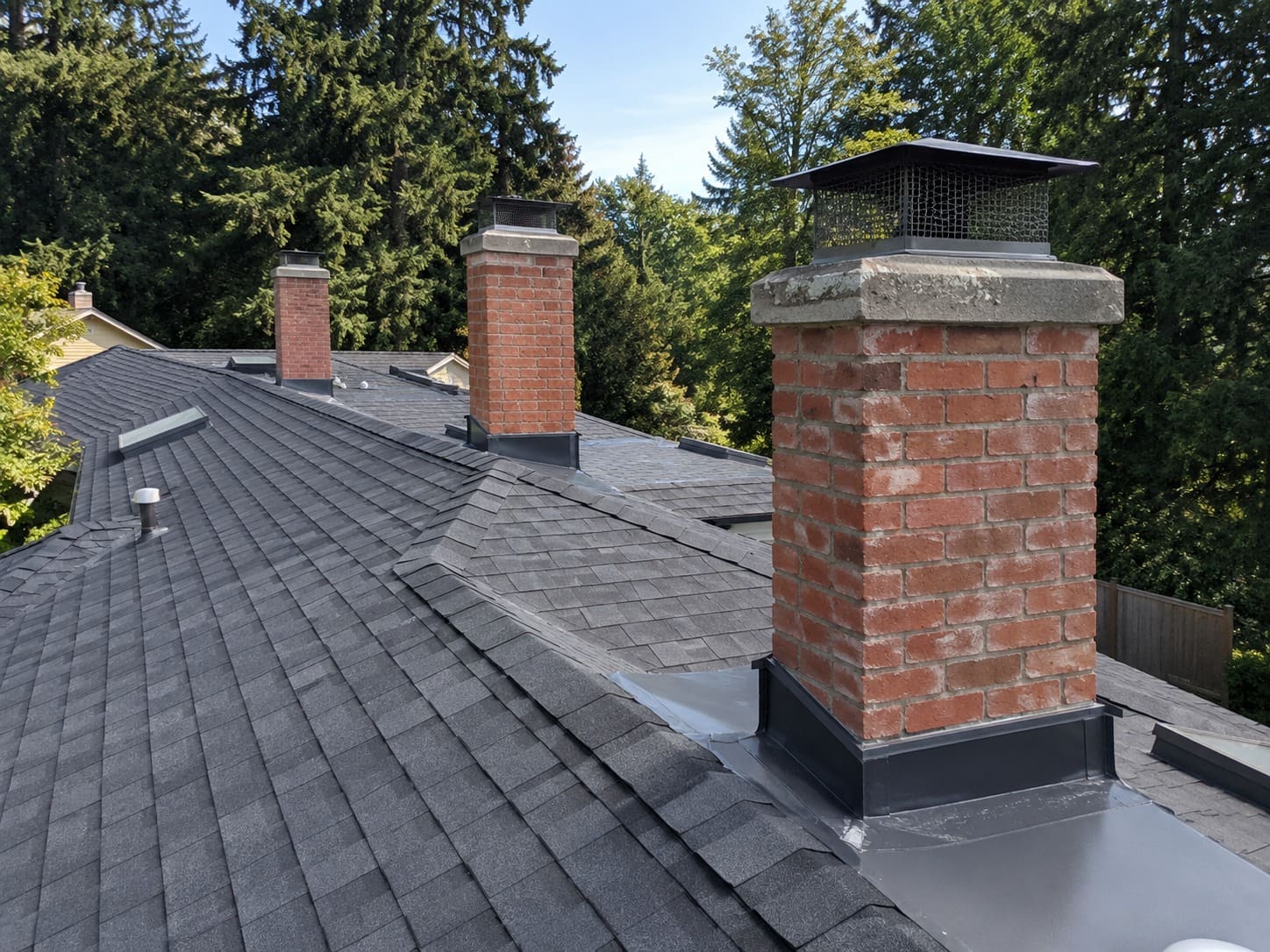 Chimney flashing repair on a roof in Gresham, Oregon