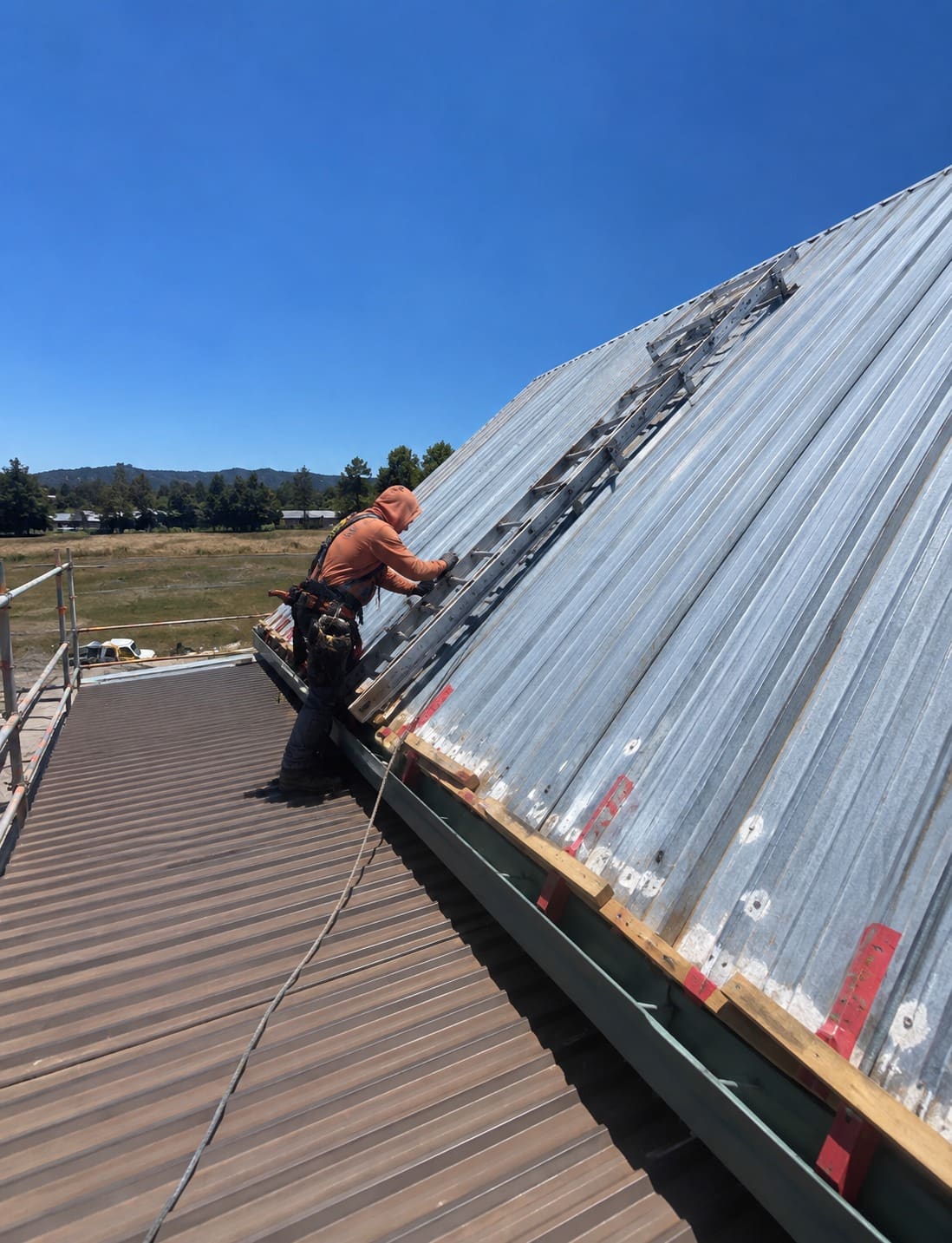Roofer repairing a metal roof in Gresham, Oregon